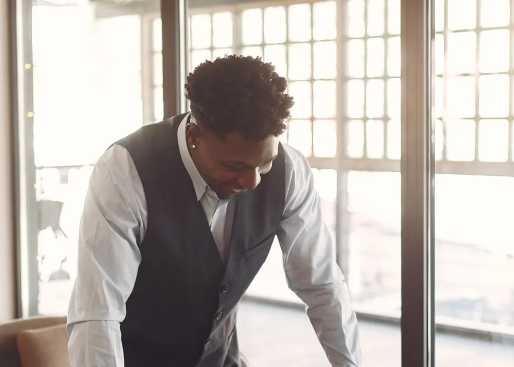 Cheerful young African male entrepreneur working on a laptop
